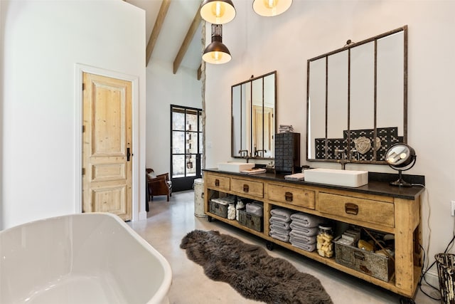 bathroom with a bath to relax in, beamed ceiling, high vaulted ceiling, and double vanity