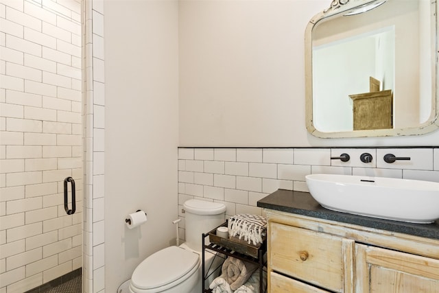 bathroom featuring tile walls, toilet, an enclosed shower, backsplash, and vanity