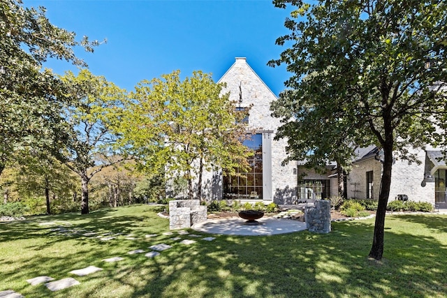 view of front of house with a front lawn and a patio area