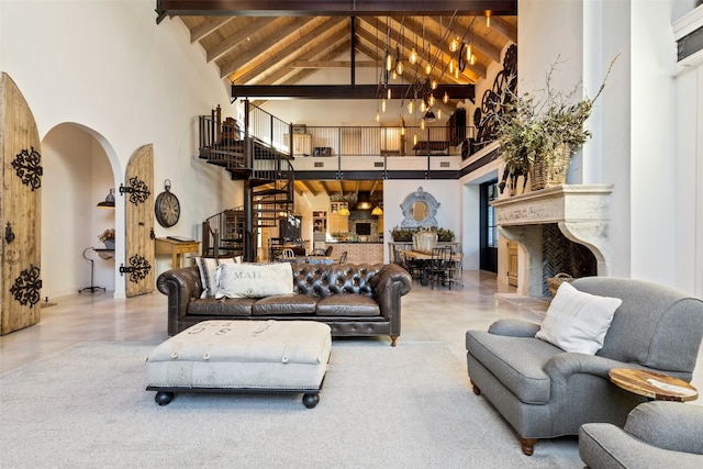 living room featuring high vaulted ceiling, light tile floors, and beamed ceiling