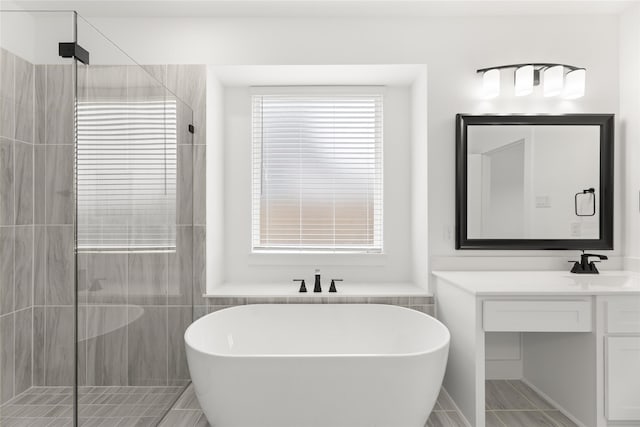 bathroom featuring independent shower and bath, vanity, and tile floors