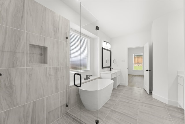 bathroom featuring tile flooring, vanity, tile walls, and independent shower and bath