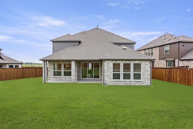 rear view of house with a lawn