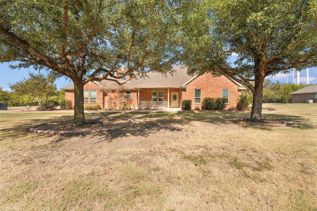 ranch-style home with a porch and a front lawn