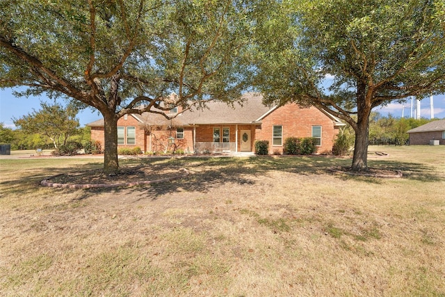 ranch-style home with a porch and a front lawn