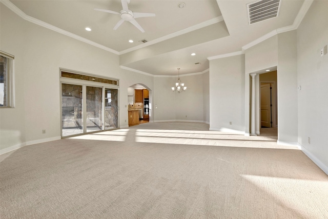 unfurnished living room featuring light colored carpet, ceiling fan with notable chandelier, and ornamental molding