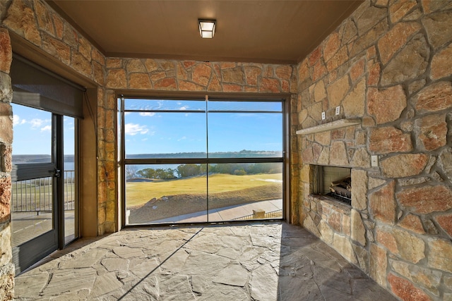 interior space featuring a fireplace and a water view