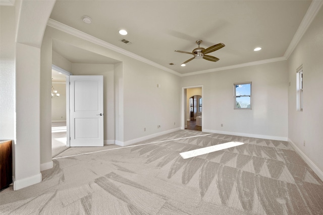 carpeted spare room with ceiling fan with notable chandelier and ornamental molding