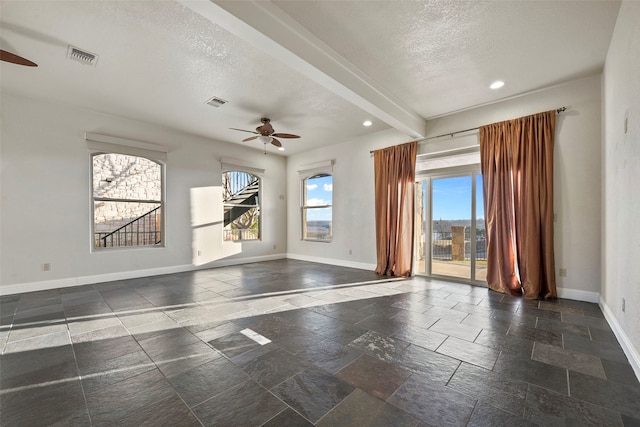 unfurnished room with beam ceiling, ceiling fan, and a textured ceiling