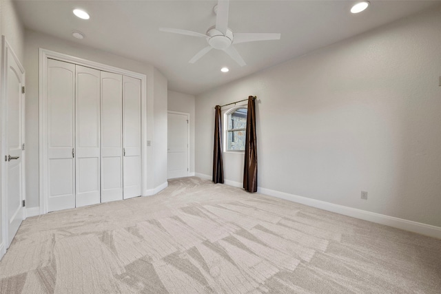 unfurnished bedroom with ceiling fan, a closet, and light colored carpet