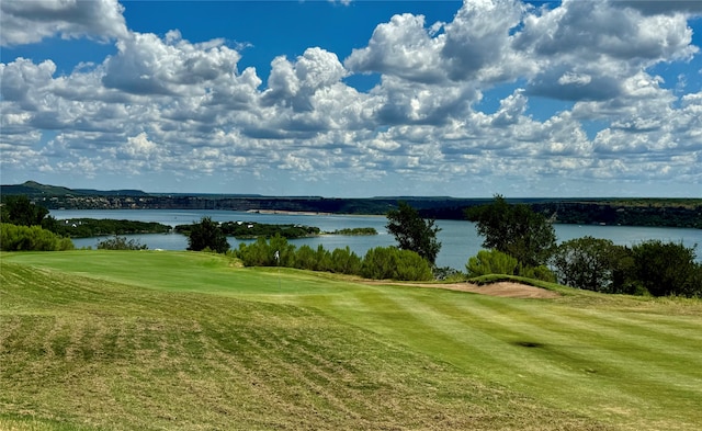 view of community featuring a water view and a lawn