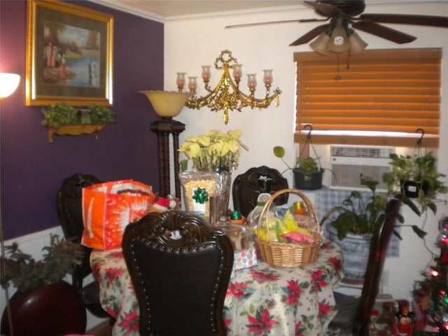 dining space with ceiling fan and crown molding