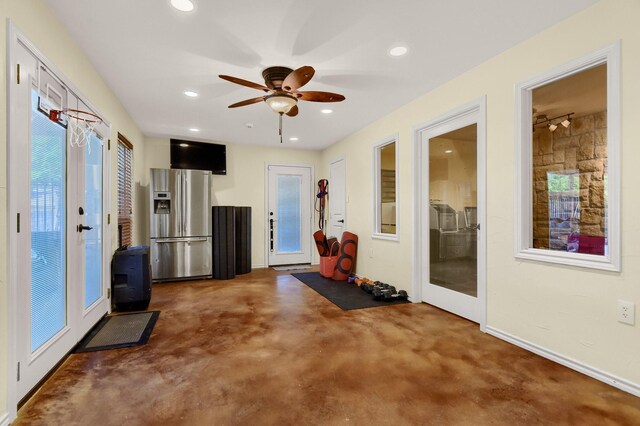 exercise area featuring dark carpet and ceiling fan