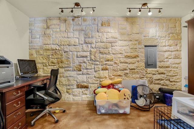 home office featuring concrete floors, electric panel, and rail lighting