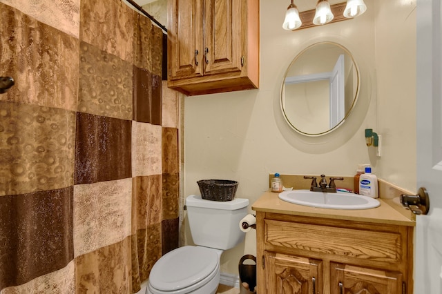 bathroom with vanity, toilet, and curtained shower