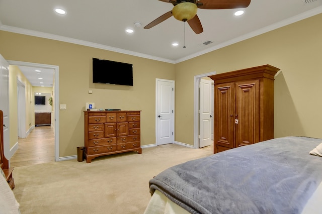 carpeted bedroom featuring ceiling fan and crown molding