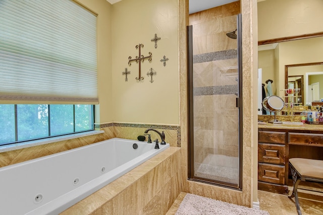 bathroom with vanity and independent shower and bath