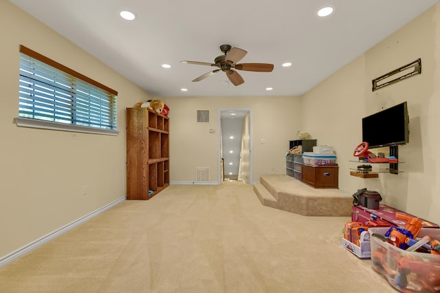 playroom featuring ceiling fan and light carpet