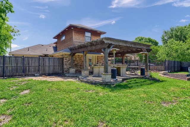 back of house with a lawn, a pergola, and exterior bar