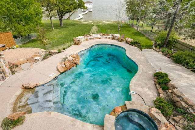 view of pool with a lawn and an in ground hot tub