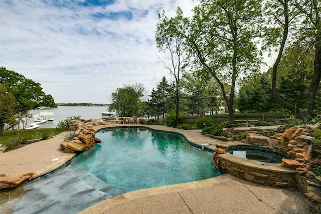 view of swimming pool featuring a patio area and an in ground hot tub