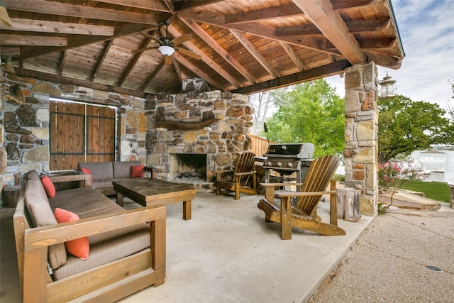 view of patio with an outdoor stone fireplace and grilling area