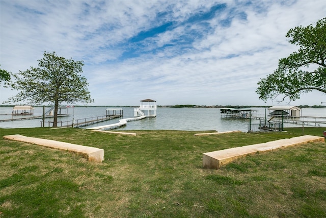 dock area with a water view and a lawn