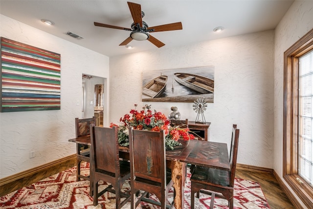 dining space with a healthy amount of sunlight, ceiling fan, and hardwood / wood-style flooring