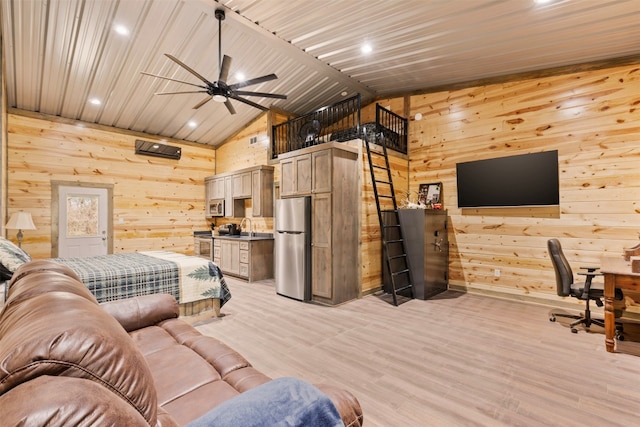 living room featuring high vaulted ceiling, ceiling fan, wooden walls, light hardwood / wood-style flooring, and sink