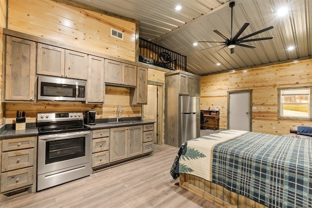 interior space with stainless steel fridge, light hardwood / wood-style floors, sink, wood walls, and wooden ceiling