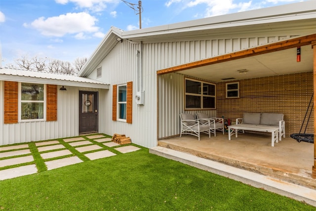 back of house featuring a lawn and a patio