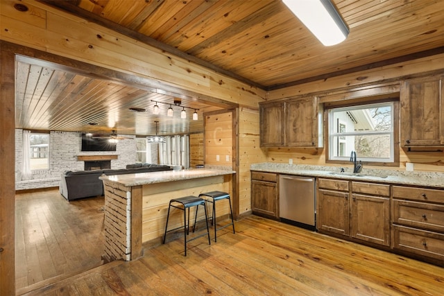 kitchen featuring wooden ceiling, dishwasher, sink, and light wood-type flooring