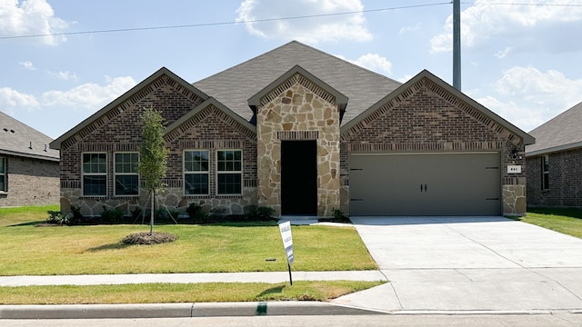 view of front of house with a garage and a front yard