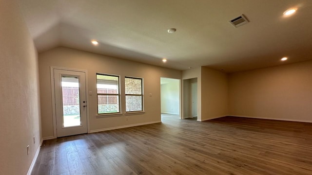 unfurnished room with lofted ceiling and dark hardwood / wood-style flooring