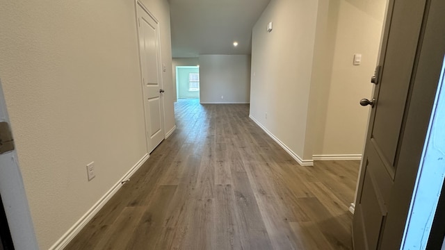 hall with hardwood / wood-style floors