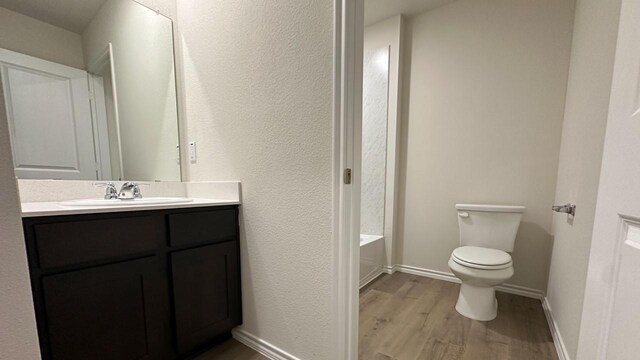 full bathroom featuring vanity, shower / bath combination, toilet, and hardwood / wood-style flooring