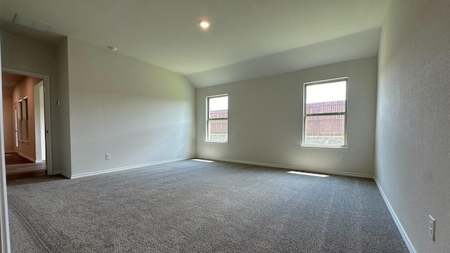 unfurnished room with vaulted ceiling and carpet