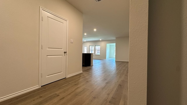 hall with hardwood / wood-style floors