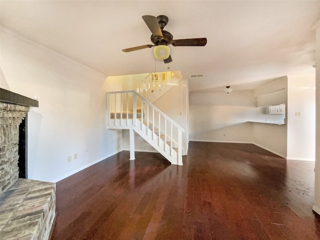 unfurnished living room featuring dark hardwood / wood-style floors and ceiling fan