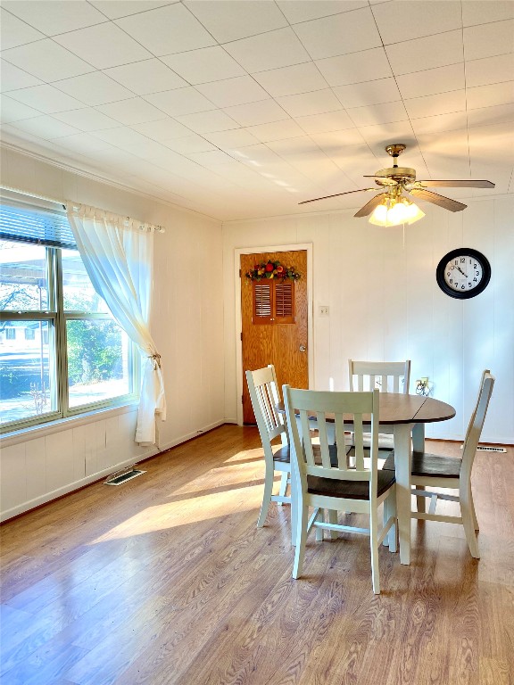 dining space featuring ceiling fan and light wood-type flooring