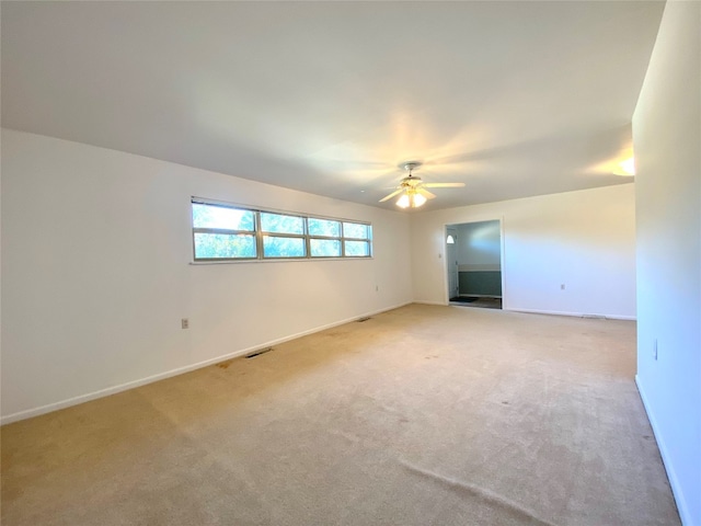 empty room featuring light carpet and ceiling fan