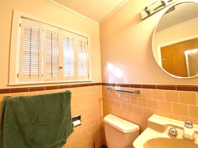 bathroom featuring tile walls, toilet, and crown molding