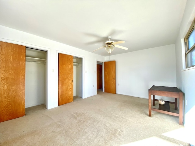 unfurnished bedroom featuring ceiling fan and light carpet