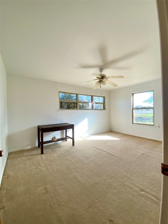 carpeted empty room with ceiling fan