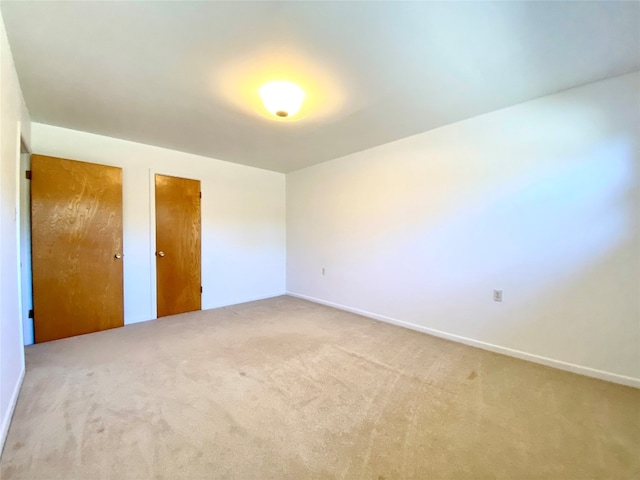 unfurnished bedroom featuring light colored carpet