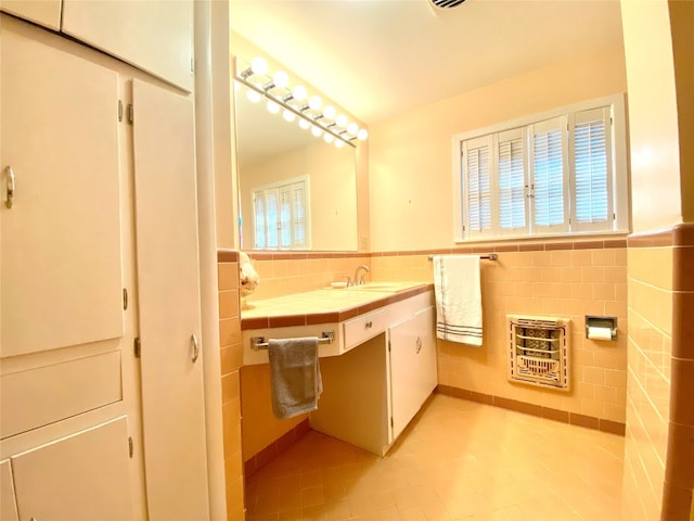 bathroom with tile flooring, tile walls, and large vanity