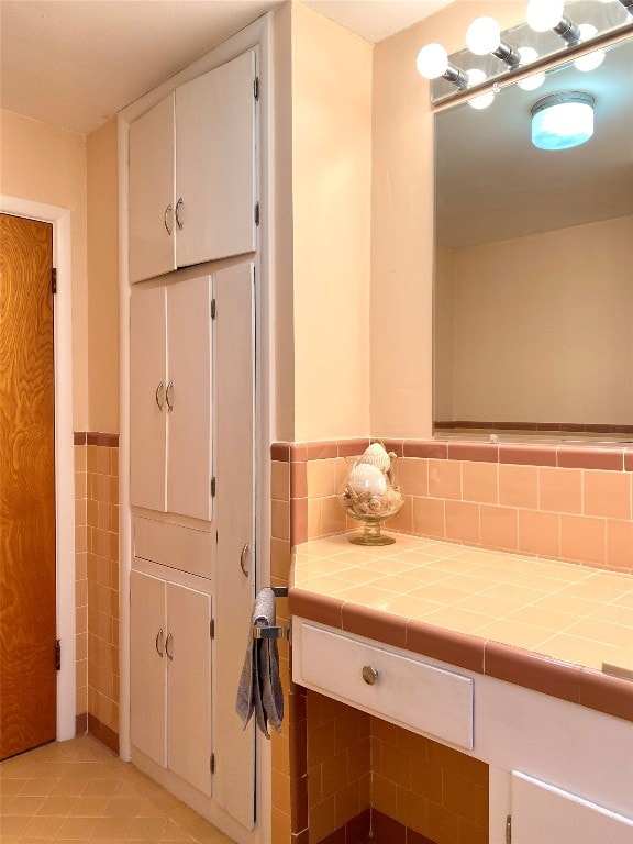 bathroom featuring tile walls, backsplash, and tile floors