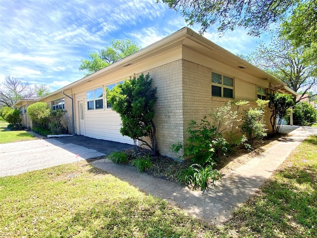 view of side of home with a lawn