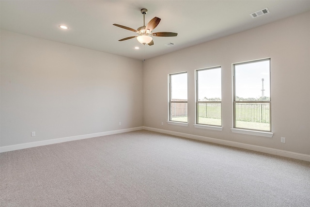 spare room featuring carpet floors and ceiling fan