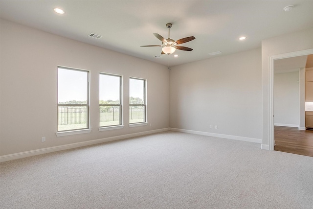 carpeted empty room with baseboards, visible vents, a ceiling fan, and recessed lighting